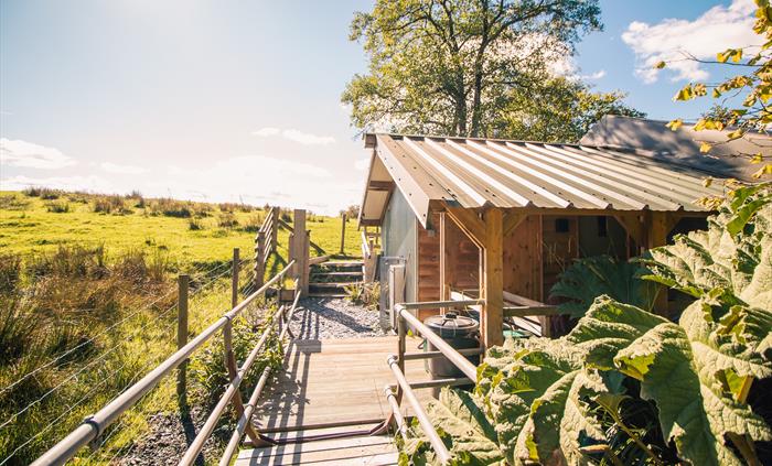 Entrance over a short bridge to your covered porch surrounding by fields and wildlife.